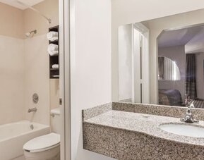 Guest bathroom with shower and bath at Super 8 By Wyndham Houston/Webster.