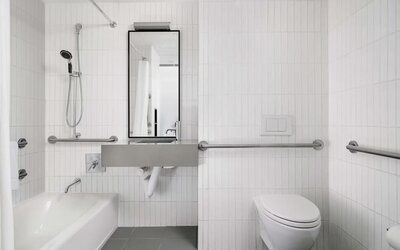 Guest bathroom with shower and bath at Arlo SoHo.

