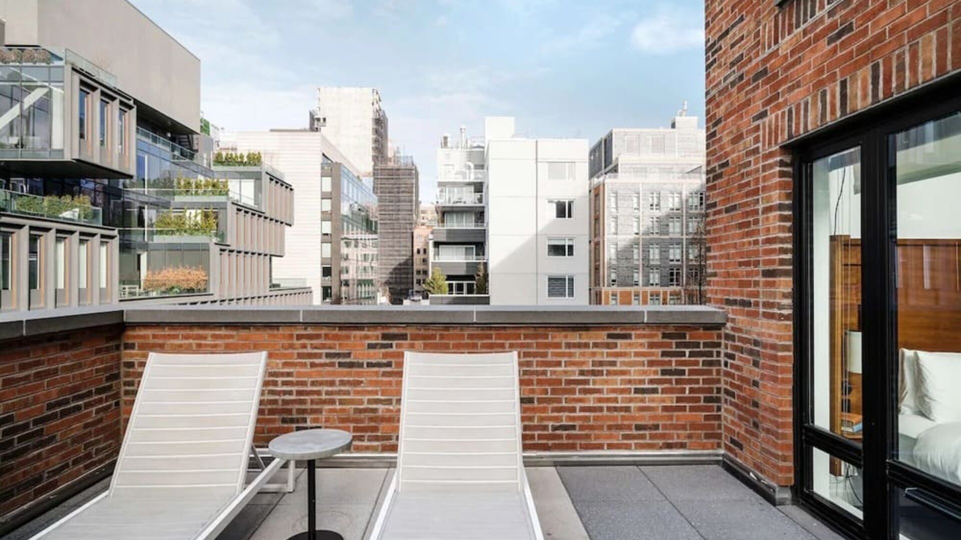 Outdoor terrace with lounge chairs at Arlo SoHo.
