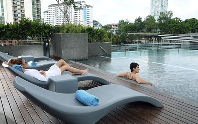 Stunning outdoor pool with lounge chairs at Capri By Fraser Johor Bahru.