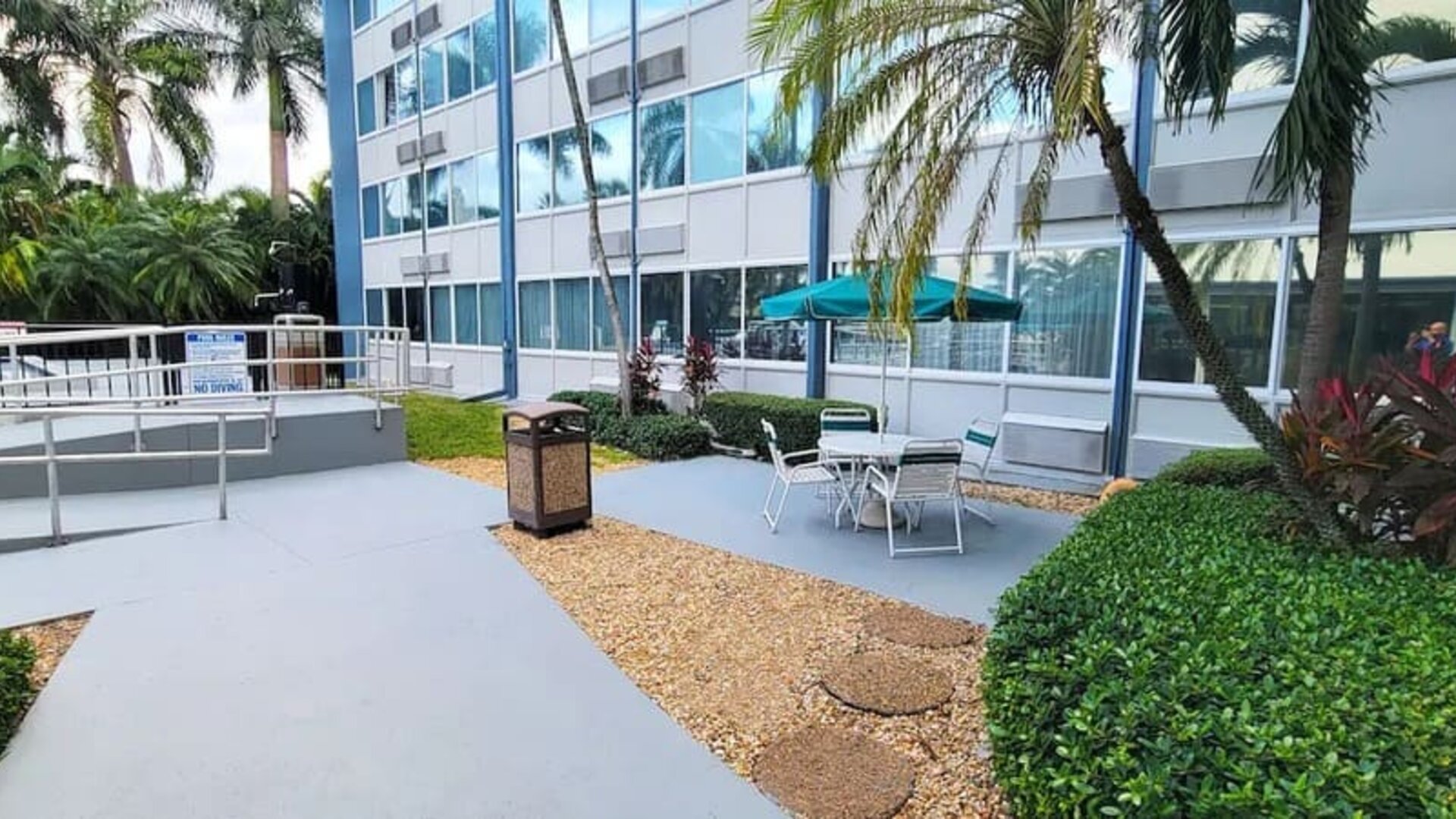 Outdoor garden and terrace at EnVision Hotel Miami International Airport.