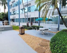 Outdoor garden and terrace at EnVision Hotel Miami International Airport.