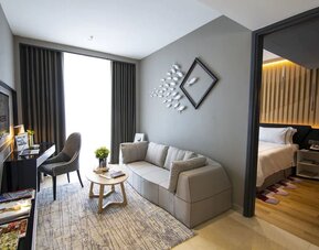 Large king room with lounge and work desk at Fraser Place Puteri Harbour.