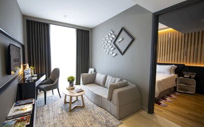 Large king room with lounge and work desk at Fraser Place Puteri Harbour.