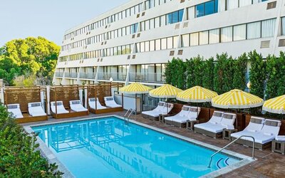 Relaxing outdoor pool with pool loungers at Hotel Dena, Pasadena Los Angeles.