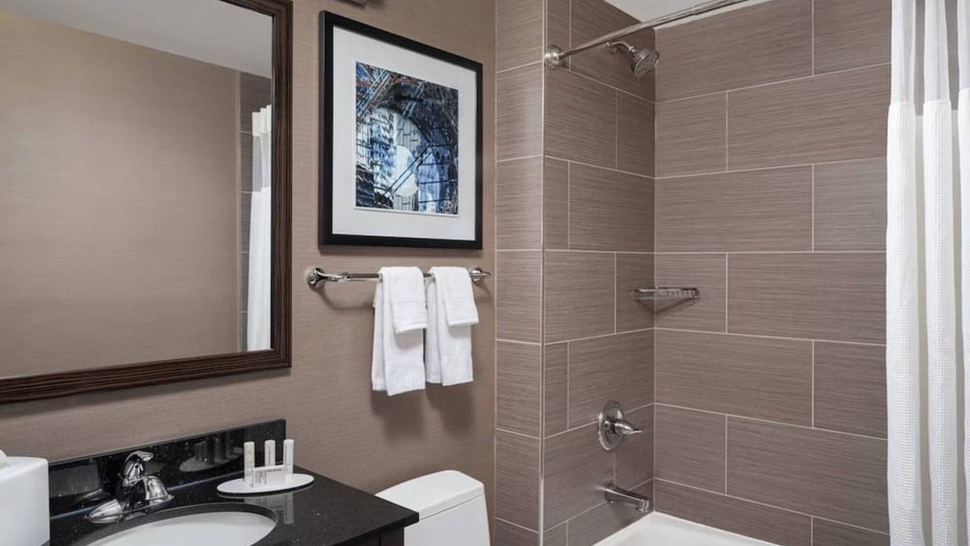 Guest bathroom with shower and bath at Fairfield Inn & Suites By Marriott New York Staten Island.