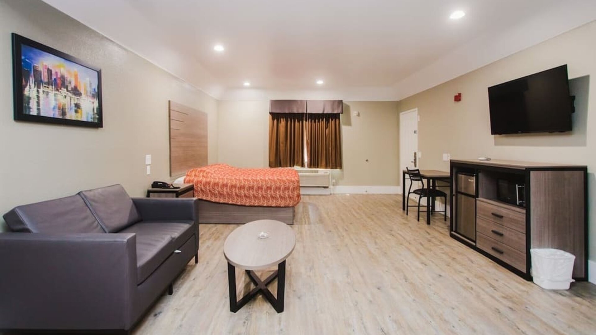 Spacious king room with TV and lounge at Palace Inn I-10 West & Beltway 8.