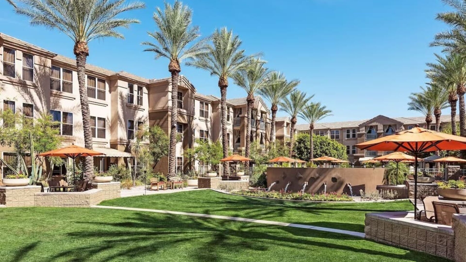 Hotel exterior with garden at Sonesta Suites Scottsdale Gainey Ranch.