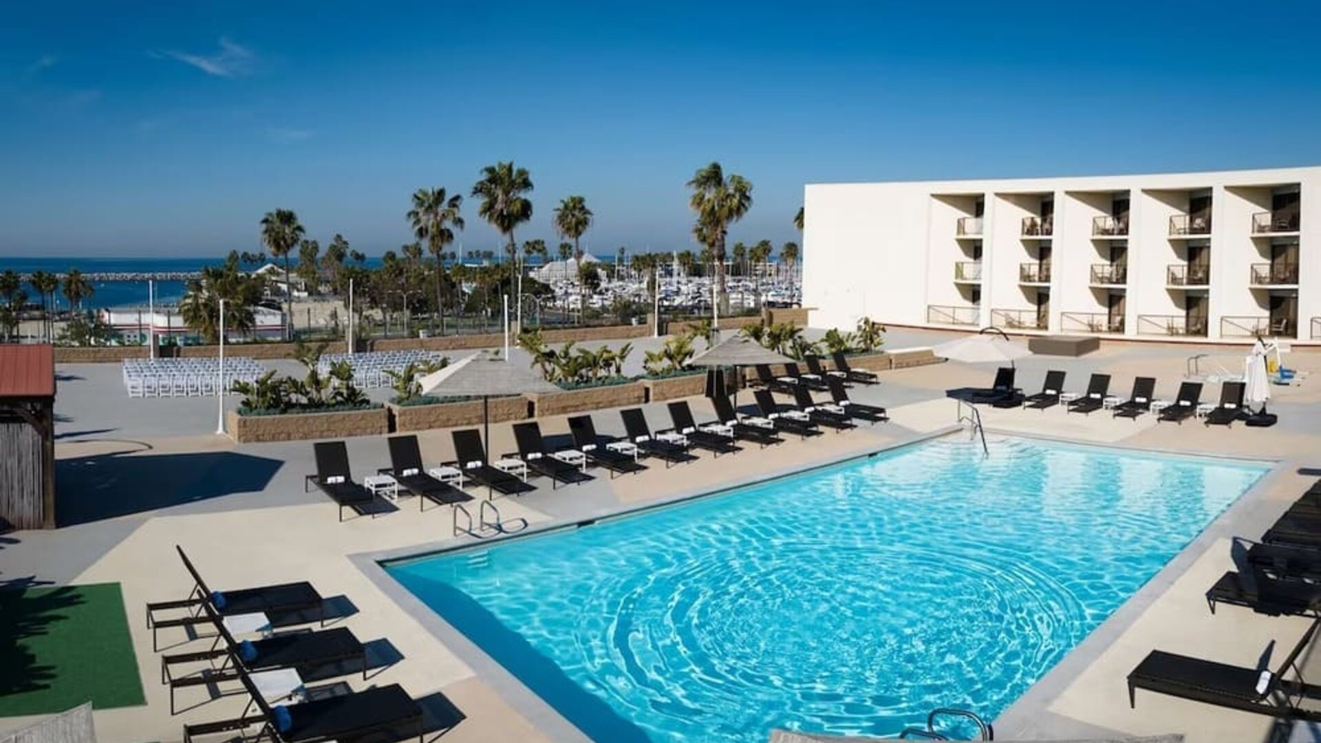Lovely outdoor pool and pool chairs at Sonesta Redondo Beach & Marina.