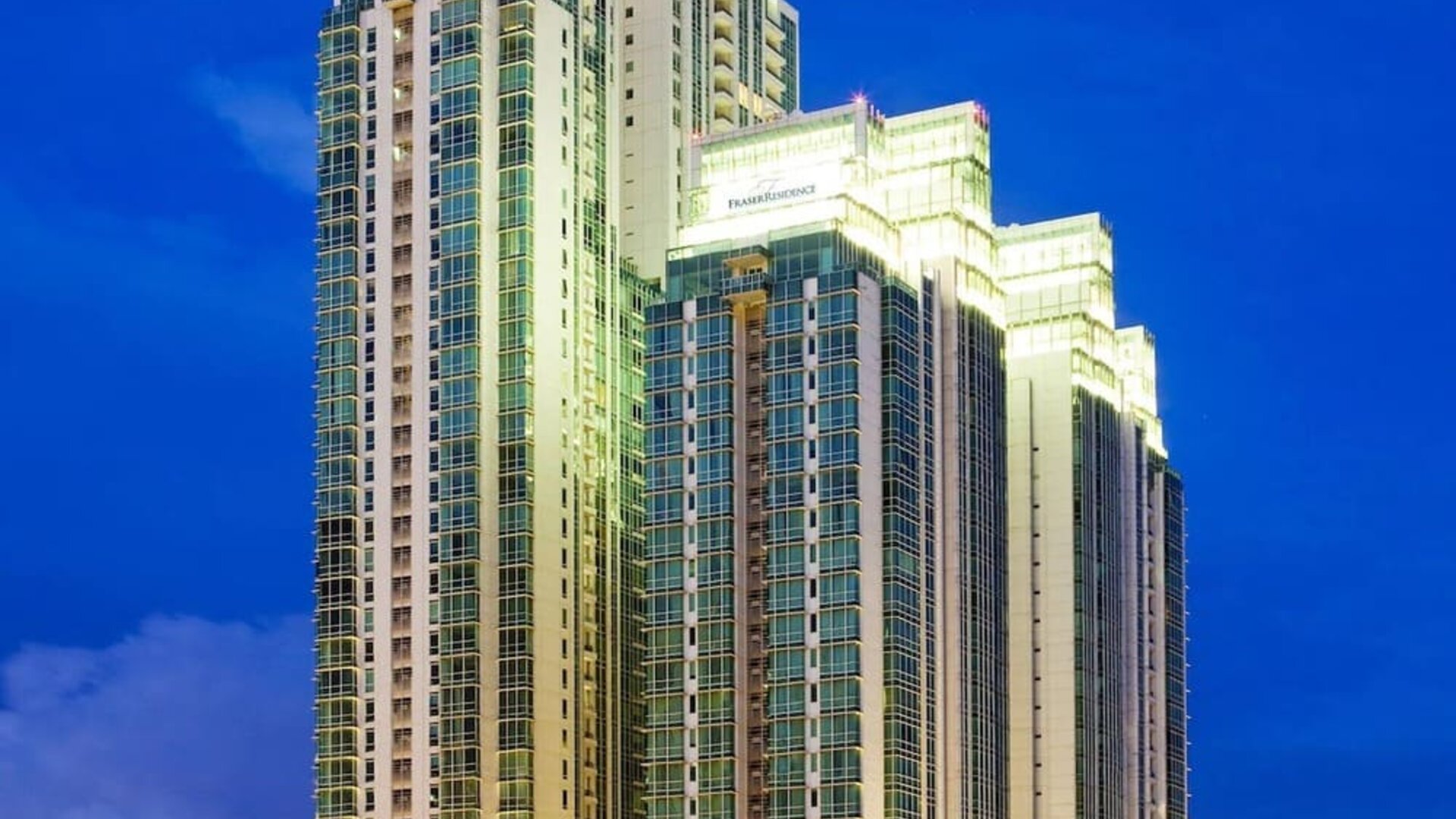 Hotel exterior at night at Fraser Residence Sudirman Jakarta.