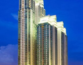 Hotel exterior at night at Fraser Residence Sudirman Jakarta.