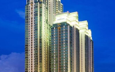 Hotel exterior at night at Fraser Residence Sudirman Jakarta.