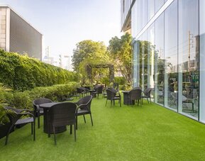 Outdoor garden with seating area at Modena By Fraser Bangkok.