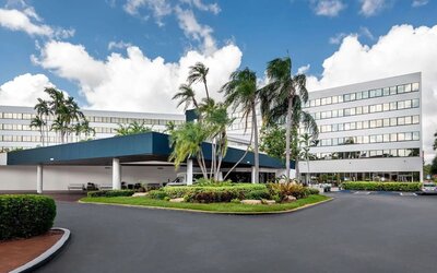 Parking and hotel exterior at Sonesta Miami Airport.