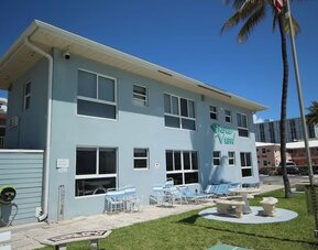 Hotel with lounge chairs at Shore View Hotel.