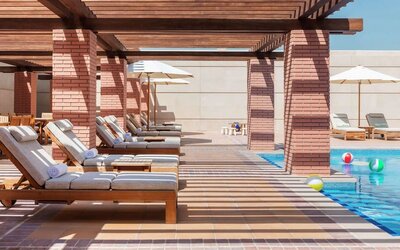 Outdoor lounge chairs at Hilton Dubai Al Habtoor City.
