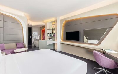 Well-lit king room at V Hotel Dubai.