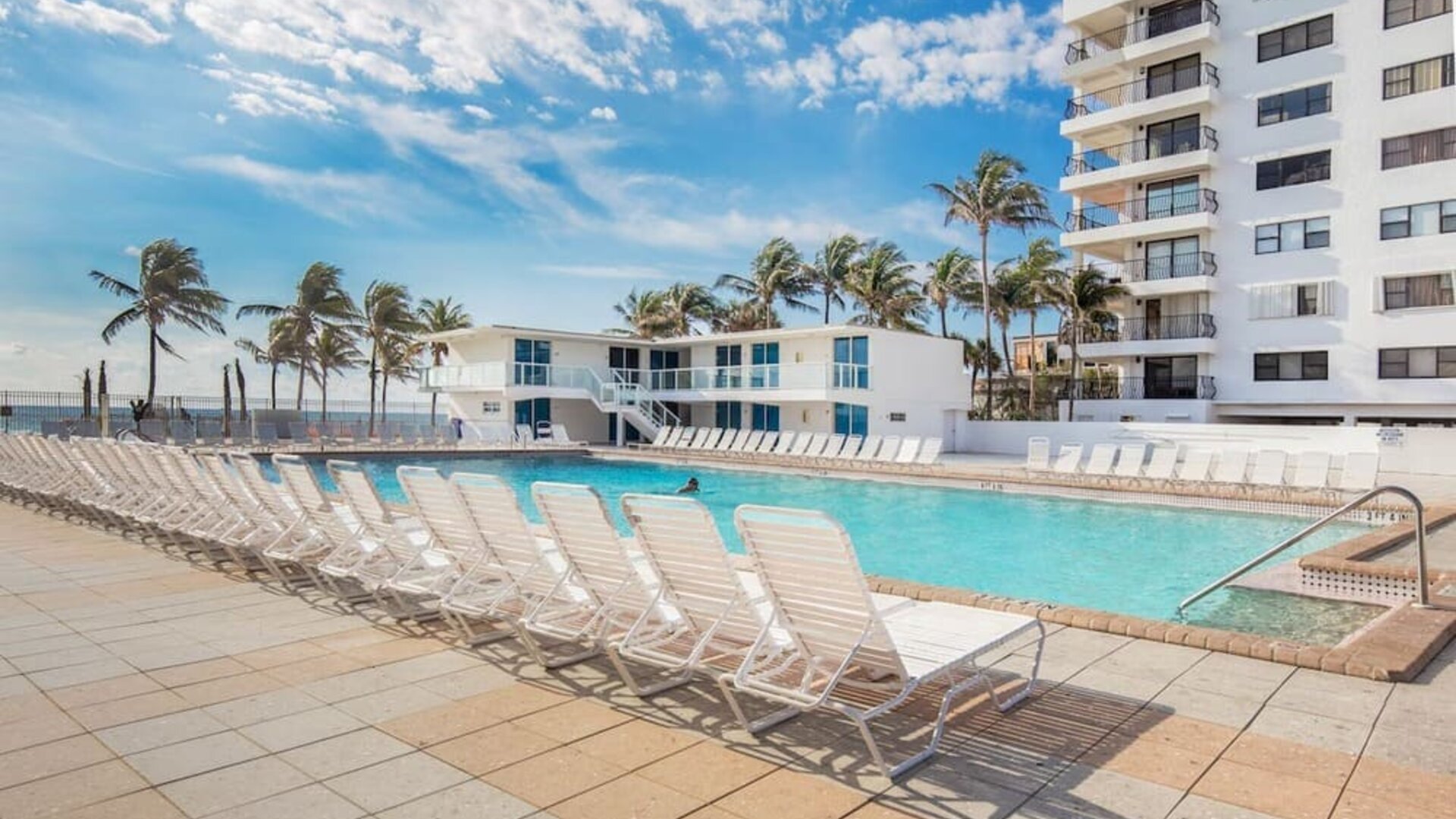 Outdoor pool and palm trees at New Point Miami.