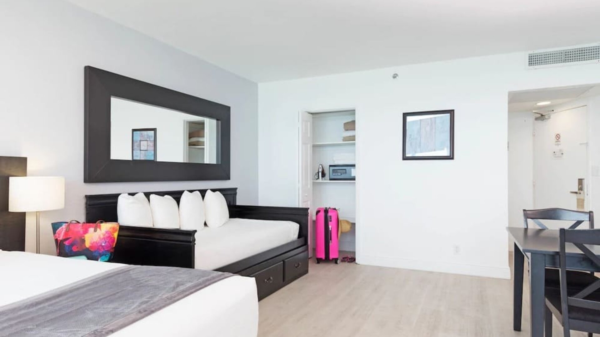 Day room with king bed and lounge chair at New Point Miami.