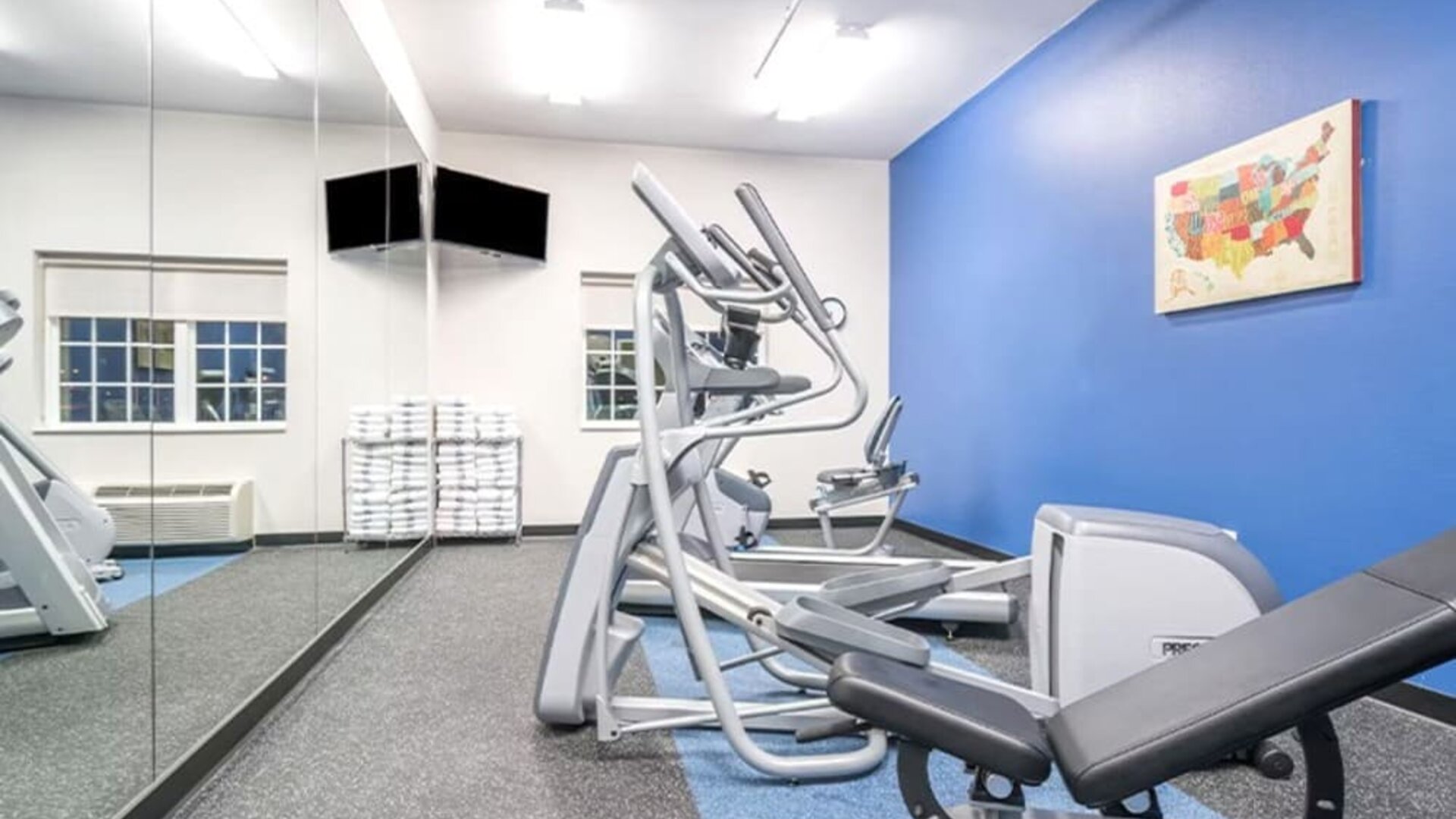 Fitness center at Coratel Inn & Suites By Jasper Rochester.
