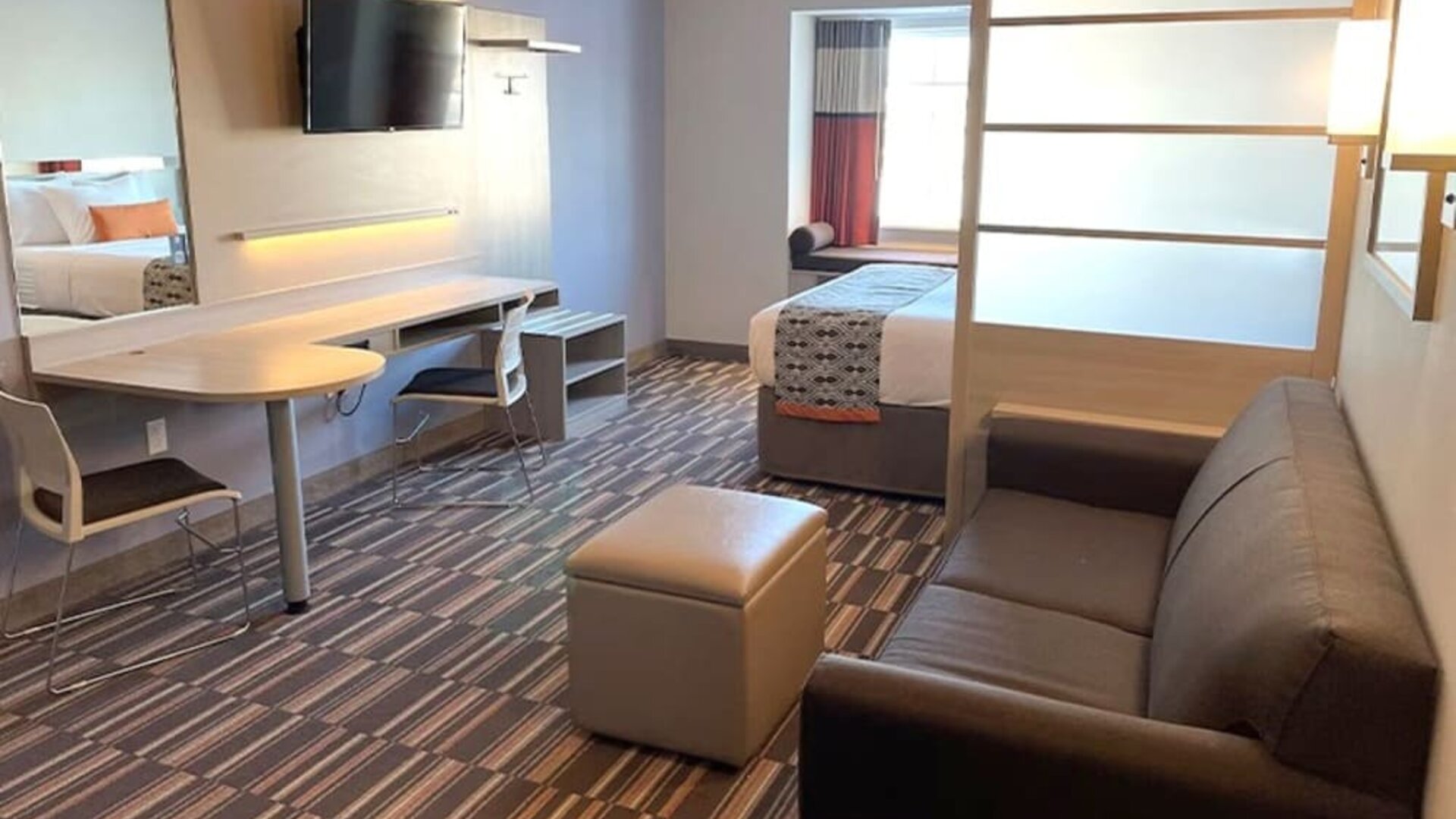 King suite with lounge area at Coratel Inn & Suites By Jasper Rochester.