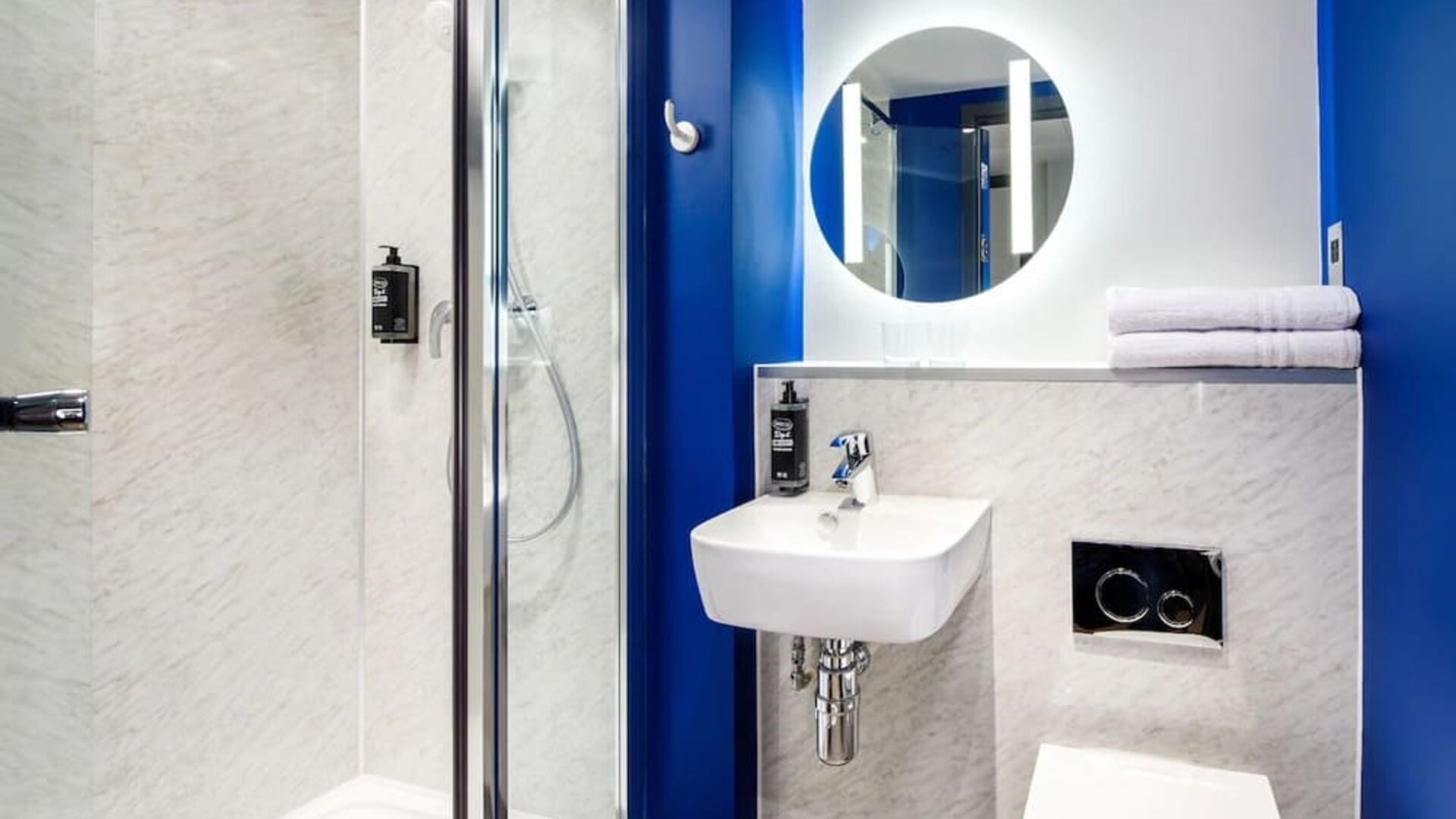 Private bathroom with shower at Ibis Budget Manchester Airport.