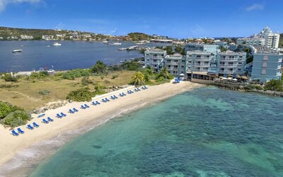 Oyster Bay Resort in St. Martin with buildings along beach and bay. 