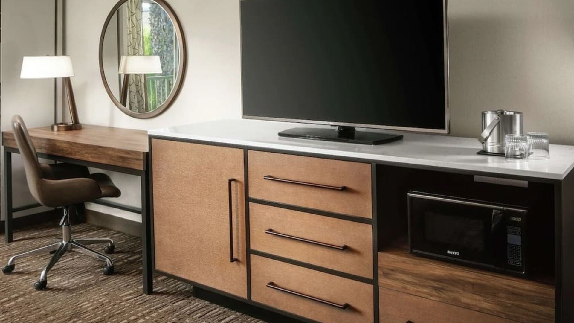 Work space with desk and TV at DoubleTree By Hilton Ontario Airport.