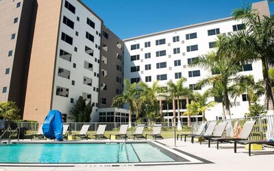 Hotel pool with loungers at Element Miami Doral.