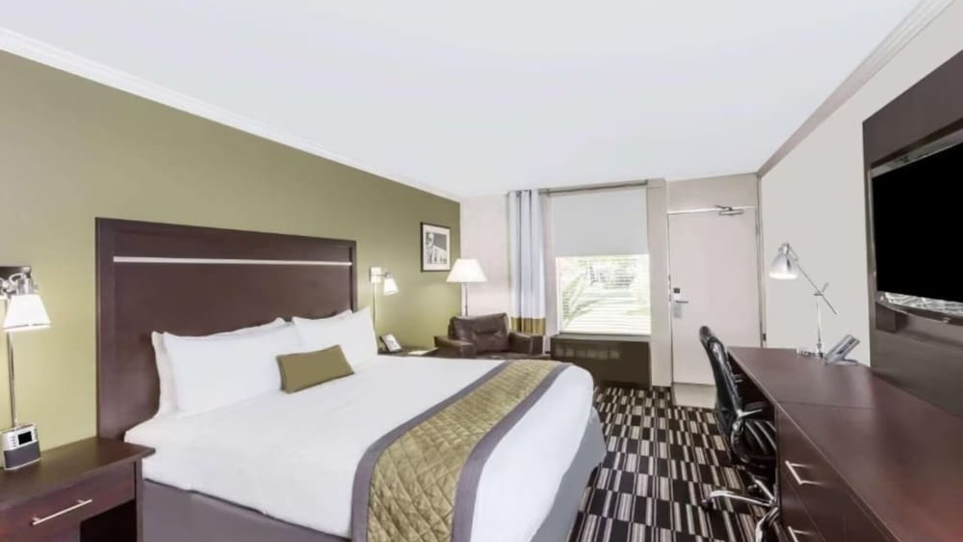 King bed with TV at Uptown Oasis San Jose Airport.