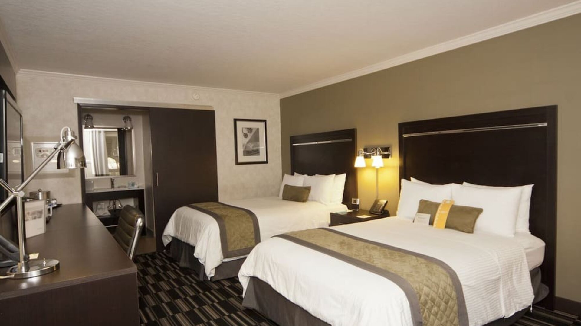 Two queen beds at Uptown Oasis San Jose Airport.