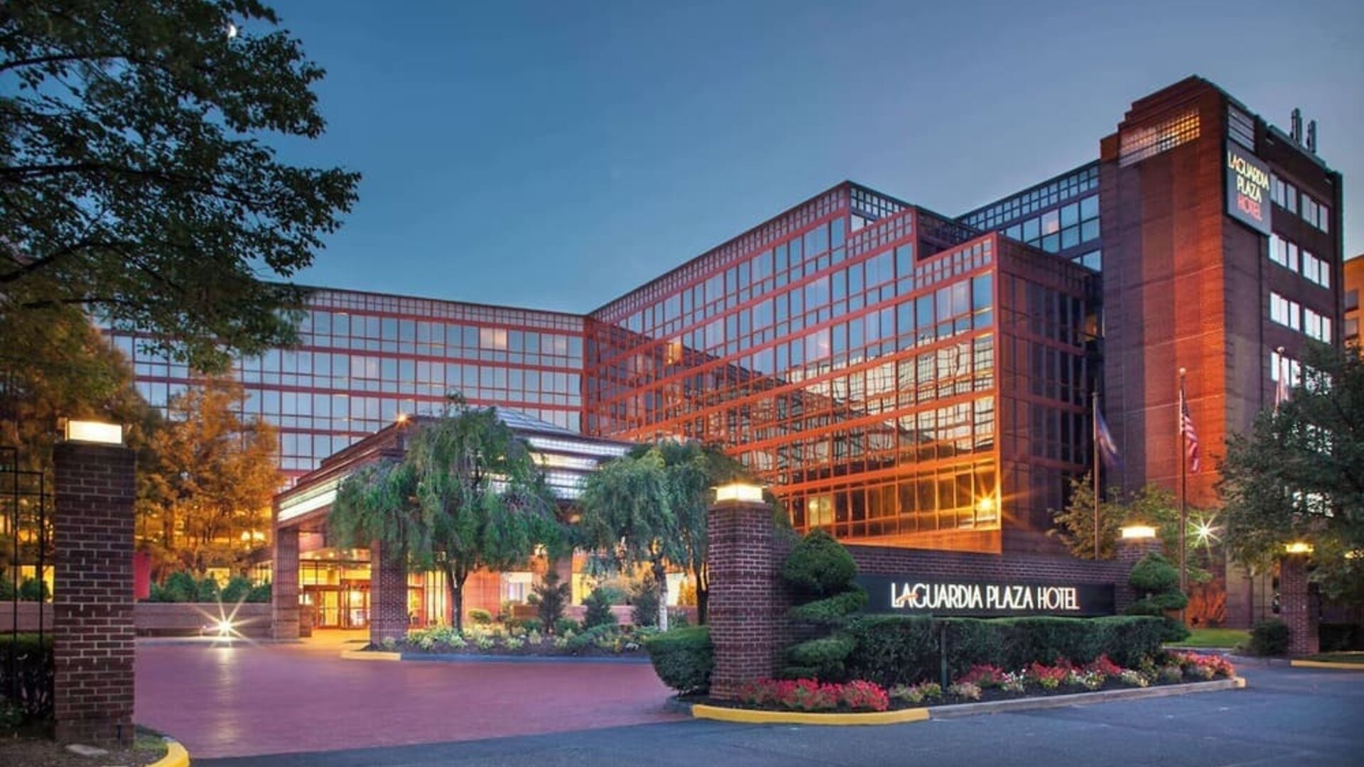 Hotel exterior at night at Laguardia Plaza Hotel.