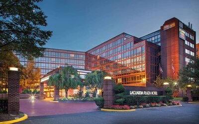Hotel exterior at night at Laguardia Plaza Hotel.