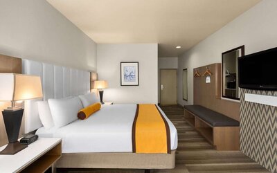 King bed with TV at Hotel Marguerite.