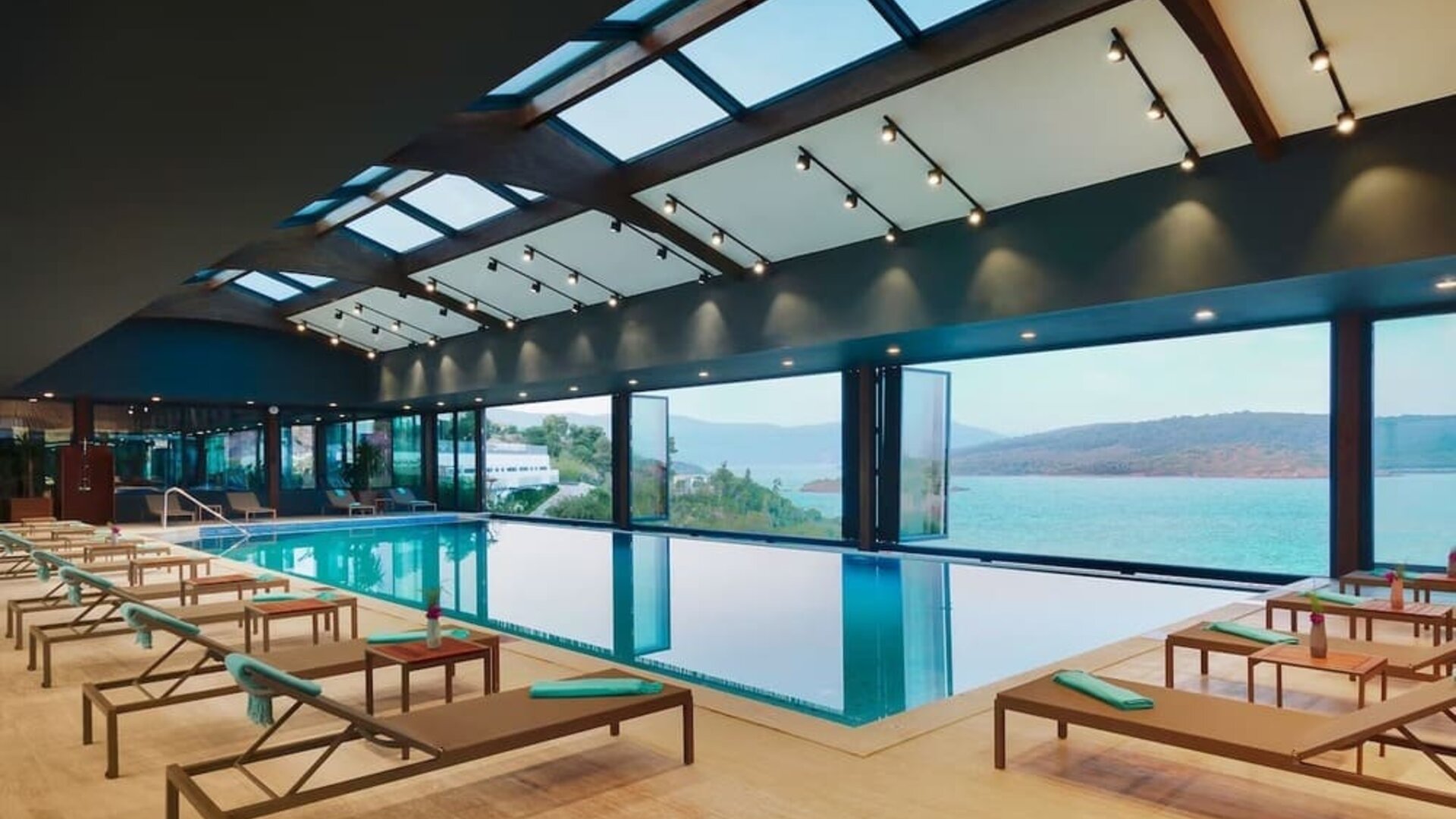 Indoor pool with loungers at Le Méridien Bodrum Beach Resort.