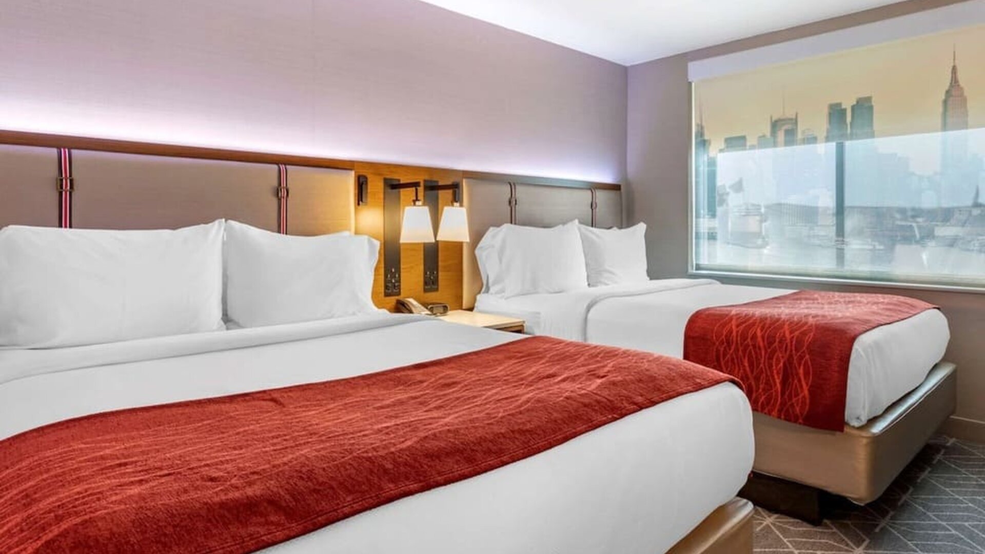 Twin bedroom with natural light at Comfort Inn JFK Airport.