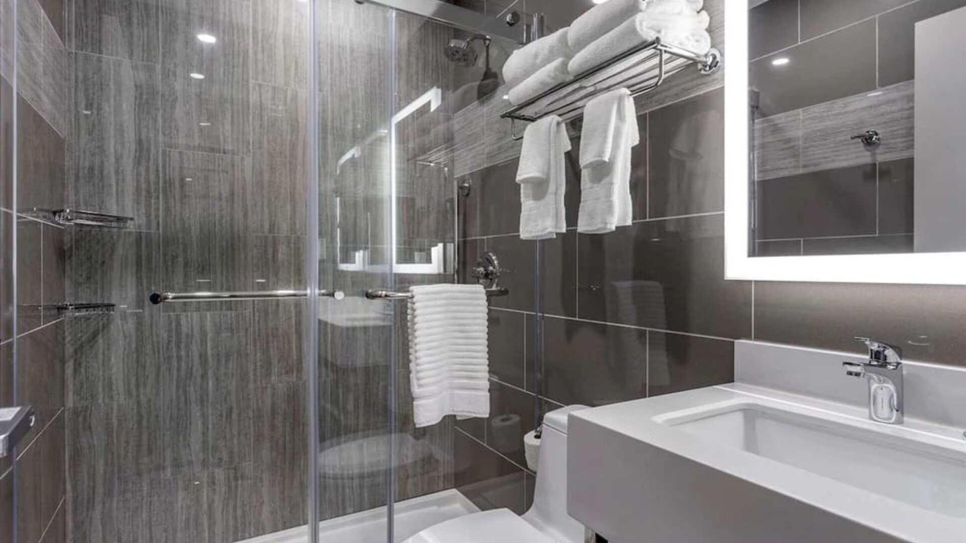 Guest bathroom with shower at Comfort Inn JFK Airport.