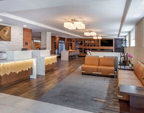 Lobby and coworking lounge at Comfort Inn JFK Airport.