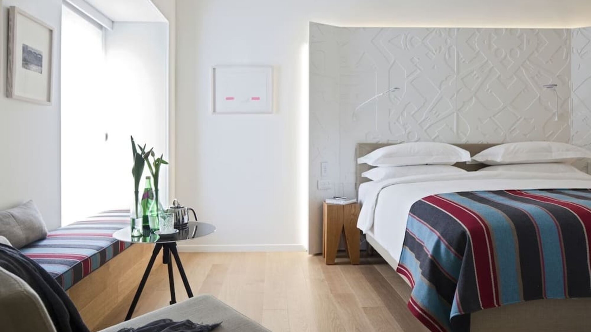 Cozy king room with natural light at Mendeli Street Hotel.