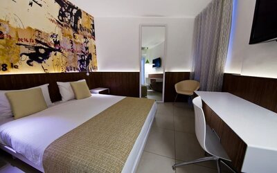 King room with TV and work station at Prima Vera Hotel.