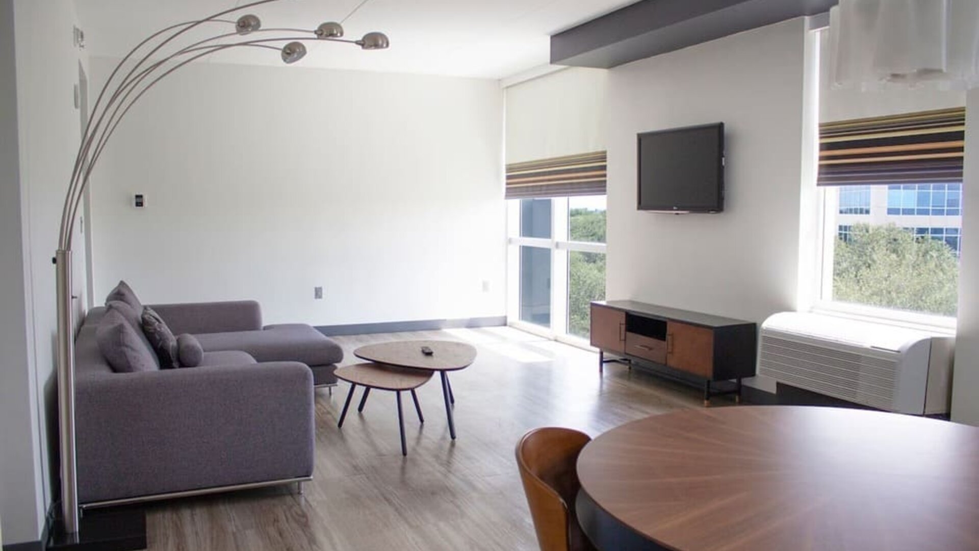 Hotel room with lounge and TV at Aloft Miami Doral.
