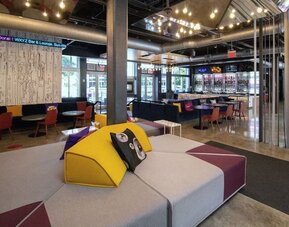 Lobby and seating area at Aloft Miami Doral.
