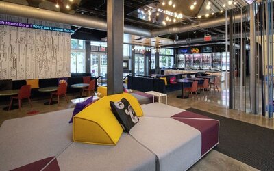 Lobby and seating area at Aloft Miami Doral.
