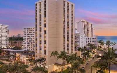 Hotel exterior at sunset at Hyatt Place Waikiki Beach.