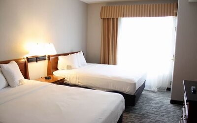 Spacious day room with two queen beds at Country Inn & Suites By Radisson, BWI Airport.