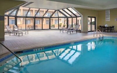 Sonesta Select Indianapolis Carmel’s indoor pool has loungers and chairs nearby.
