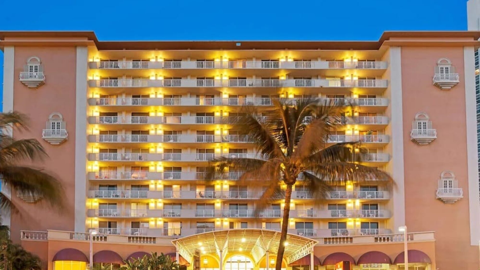 Hotel exterior at night at Ramada Plaza Marco Polo Beach Resort.