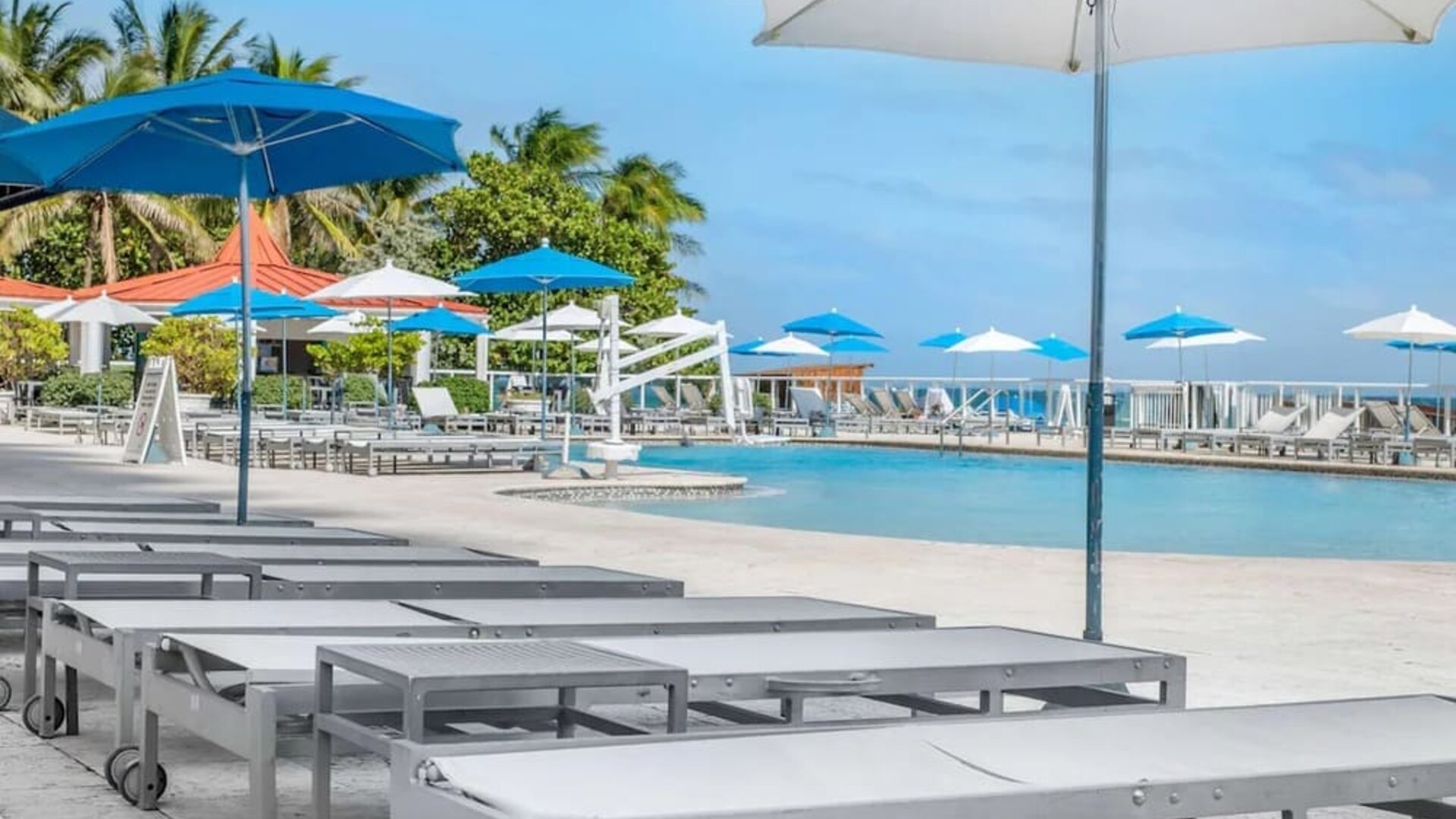 Sun loungers and umbrellas at Ramada Plaza Marco Polo Beach Resort.