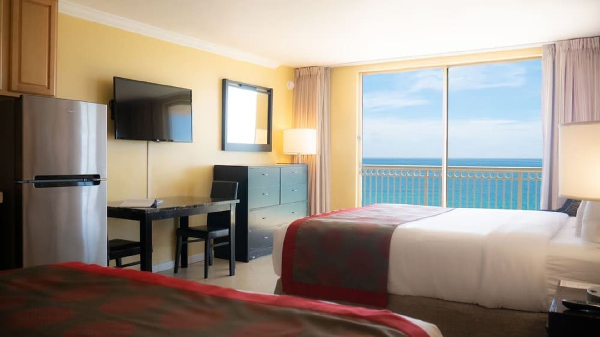 Romantic king room with TV at Ramada Plaza Marco Polo Beach Resort.
