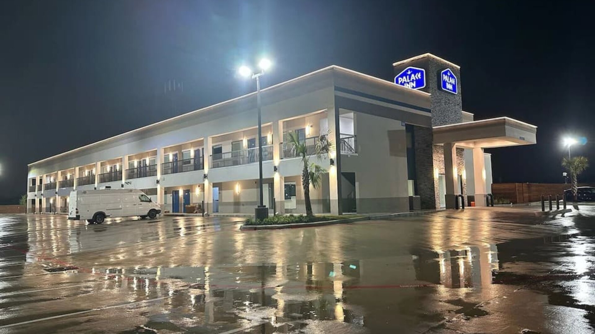 Hotel exterior and parking area at Palace Inn Blue Jones Rd. 